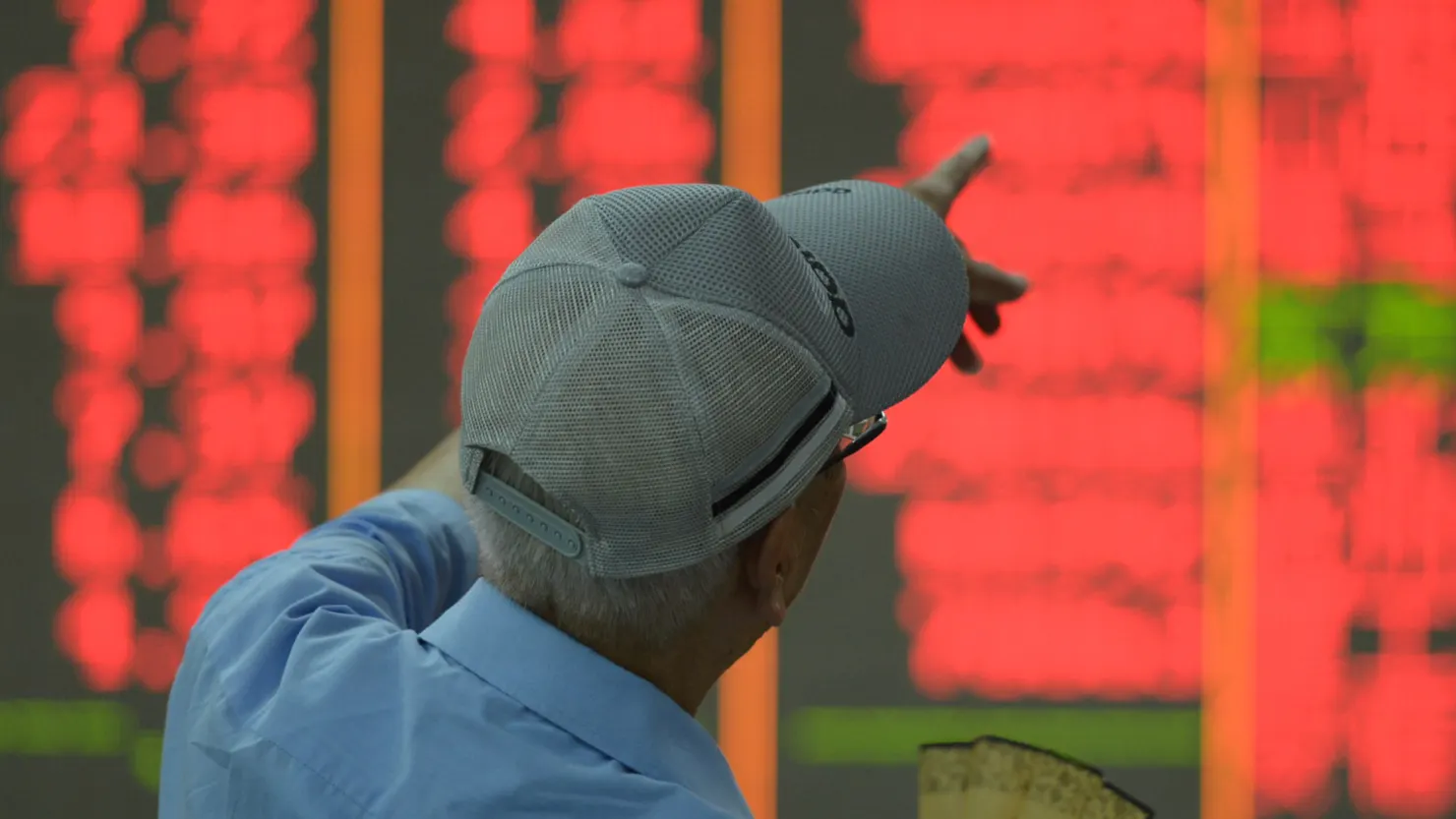 A customer watches stock market at a stock exchange in Hangzhou, China, on September 27, 2024.